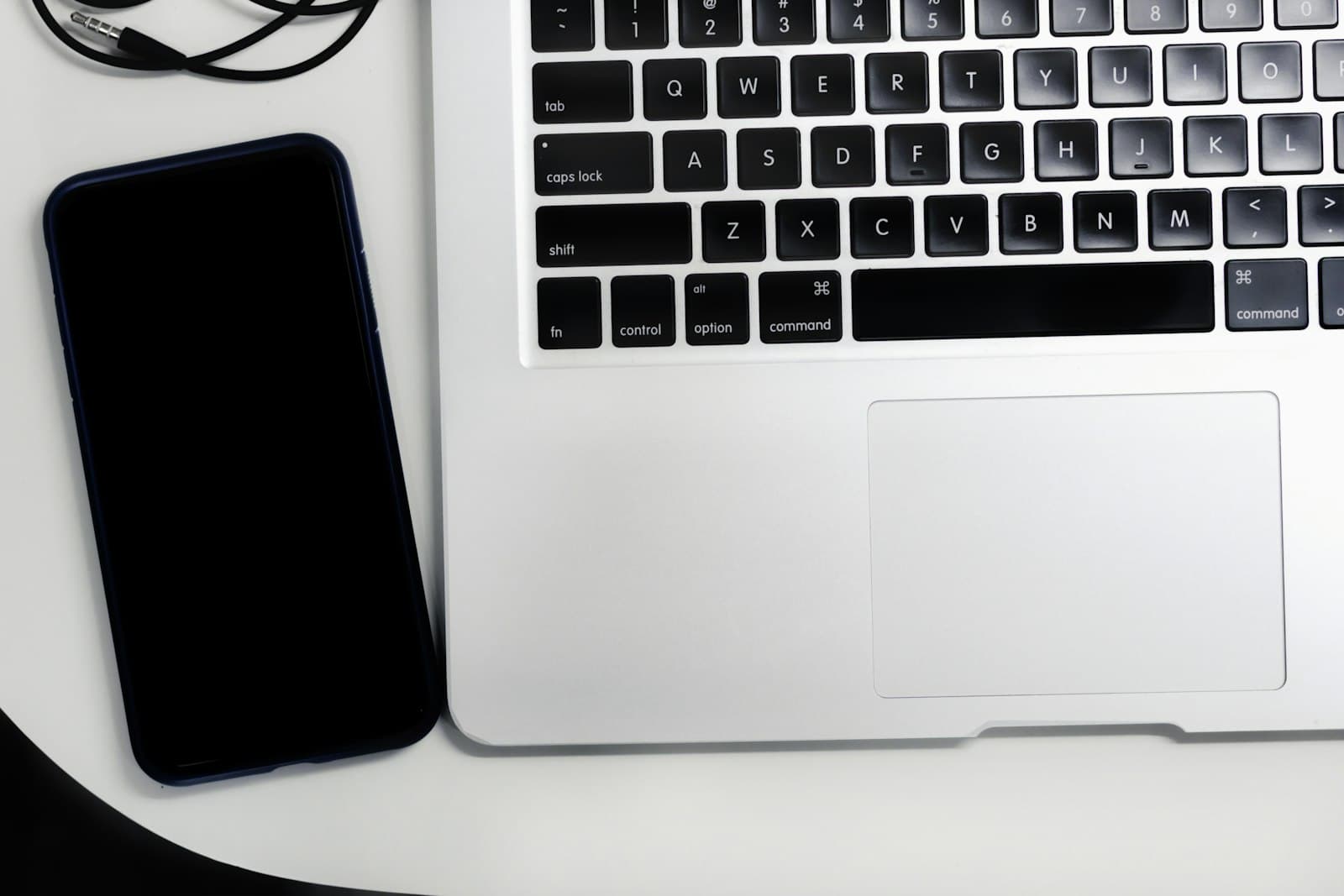 A laptop on a white table with a spreadsheet open