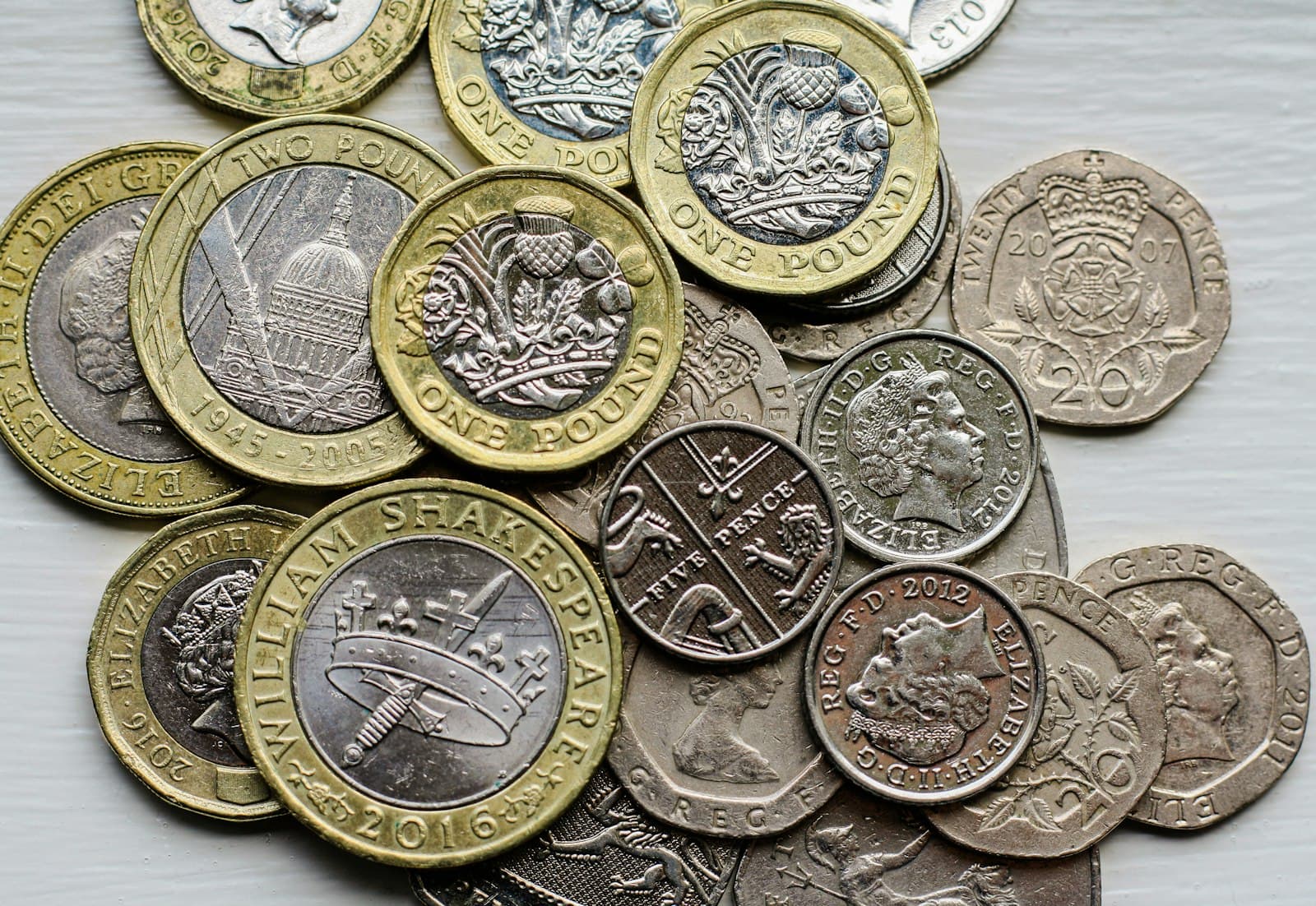 A pile of British coins on a table