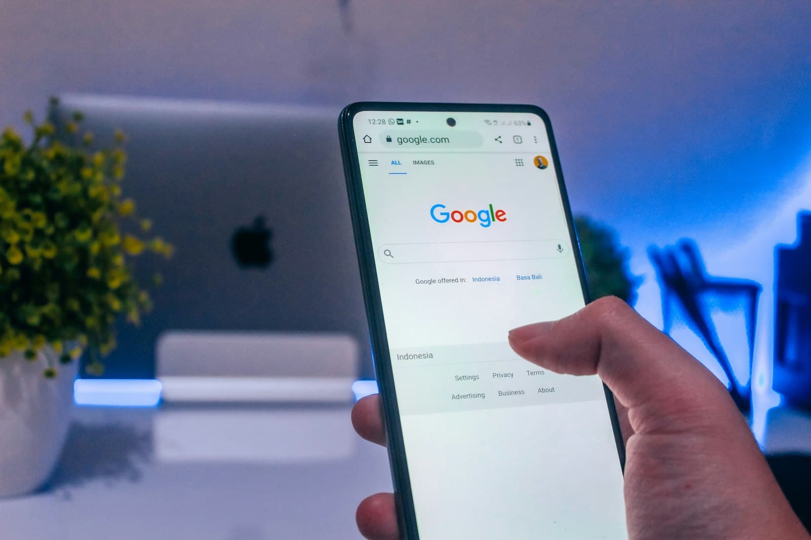 A person holding a phone with an advertising app open