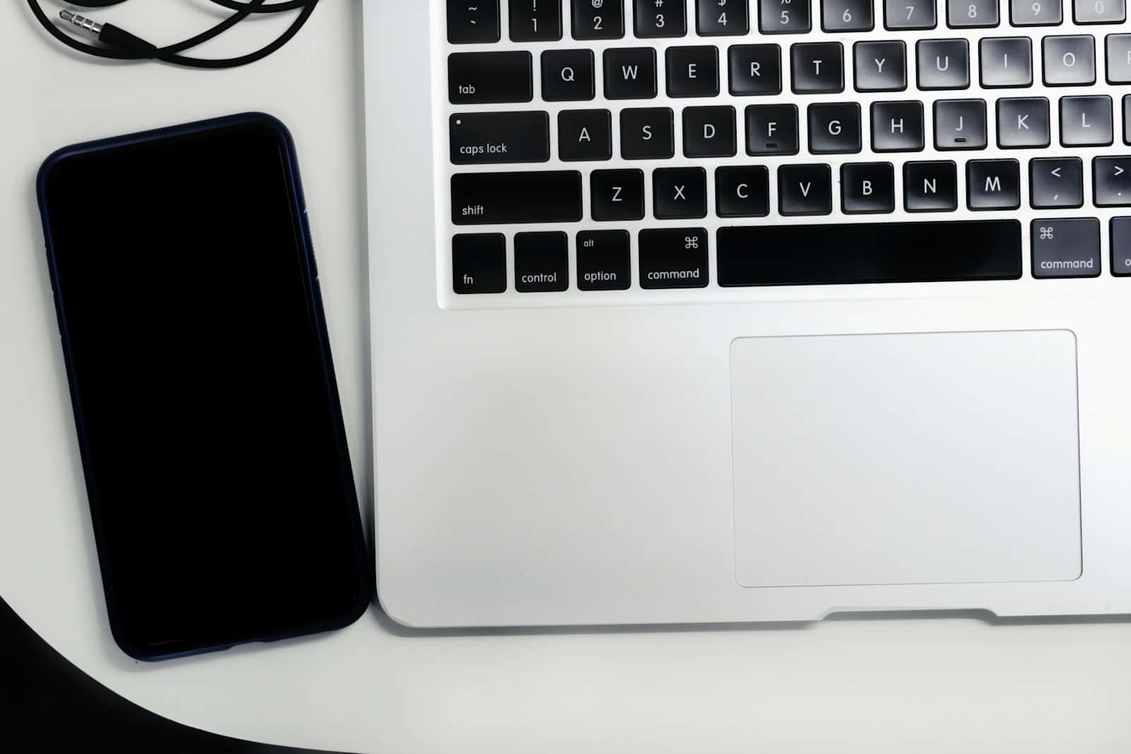 A laptop on a white table with a spreadsheet open