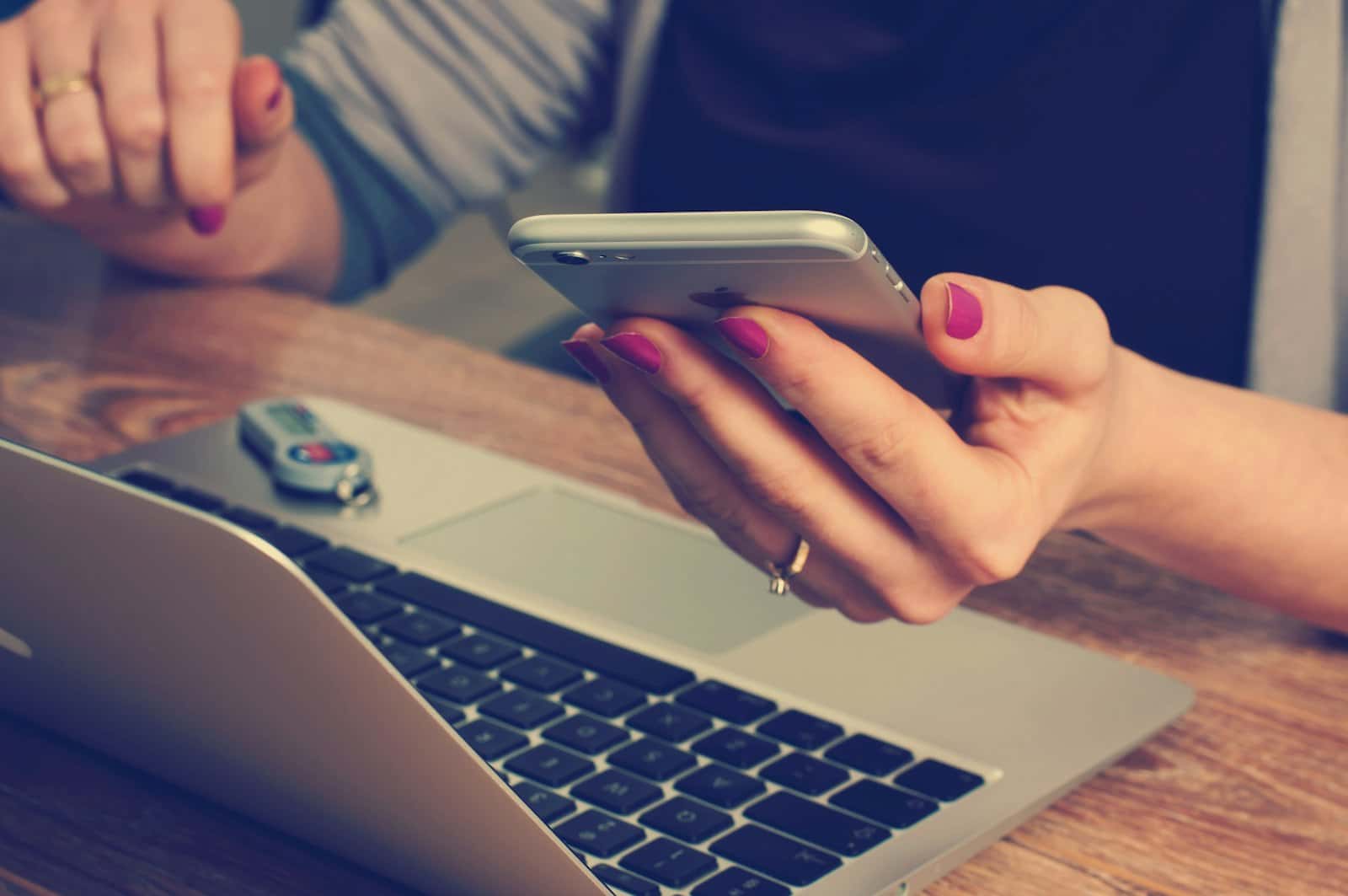 A woman holding a phone with a search results page open