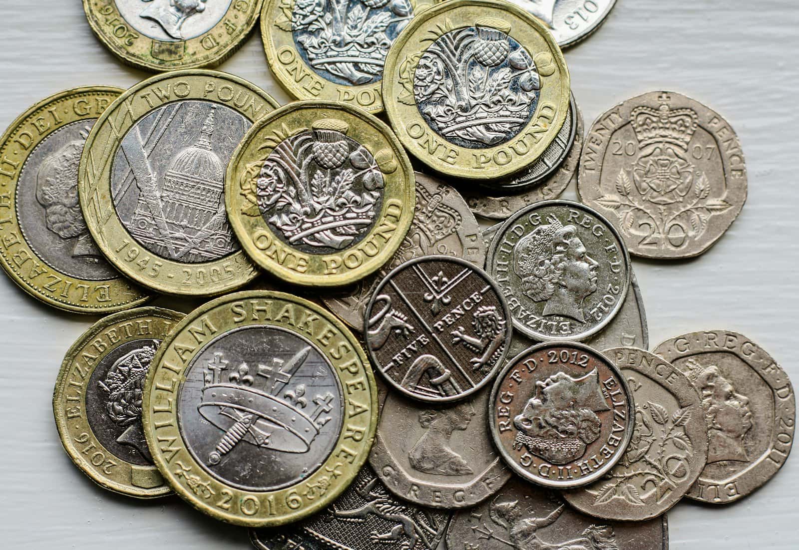 A pile of British coins on a table
