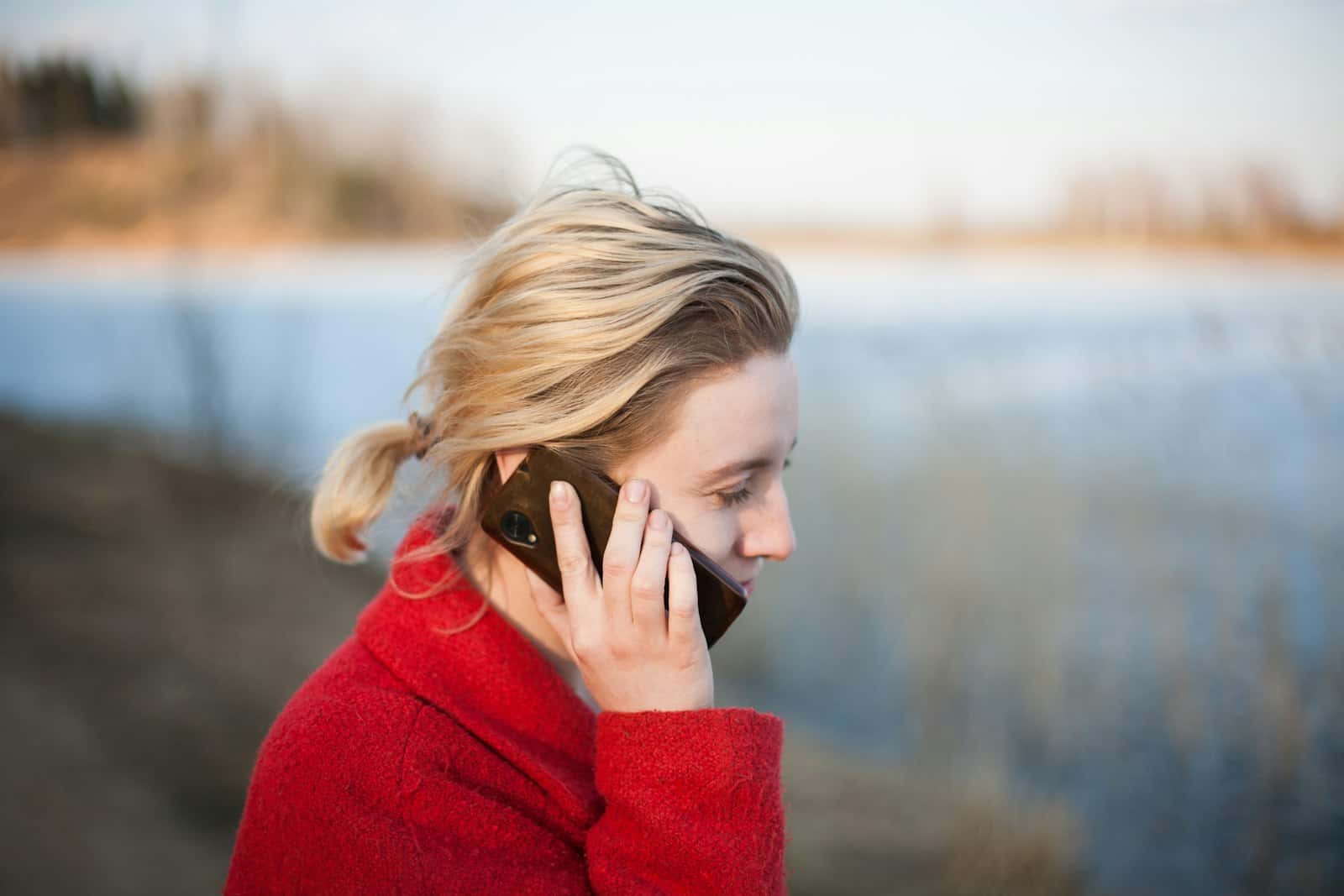 A person holding a mobile phone to answer a call