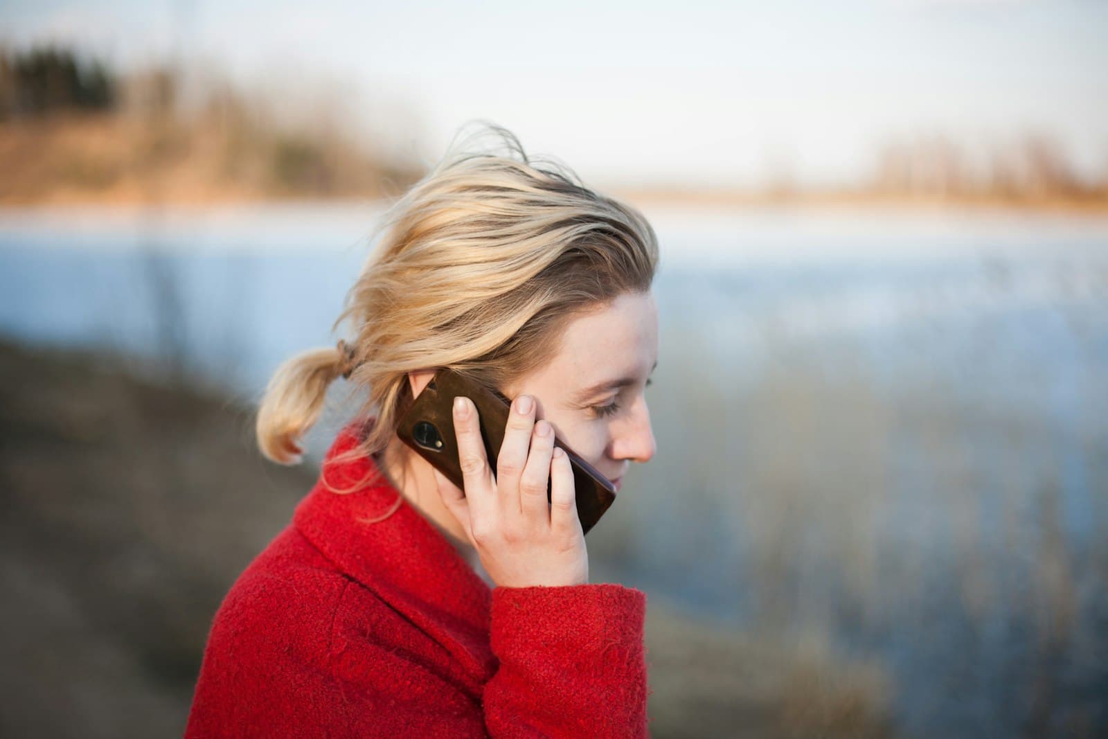 A person holding a mobile phone to answer a call